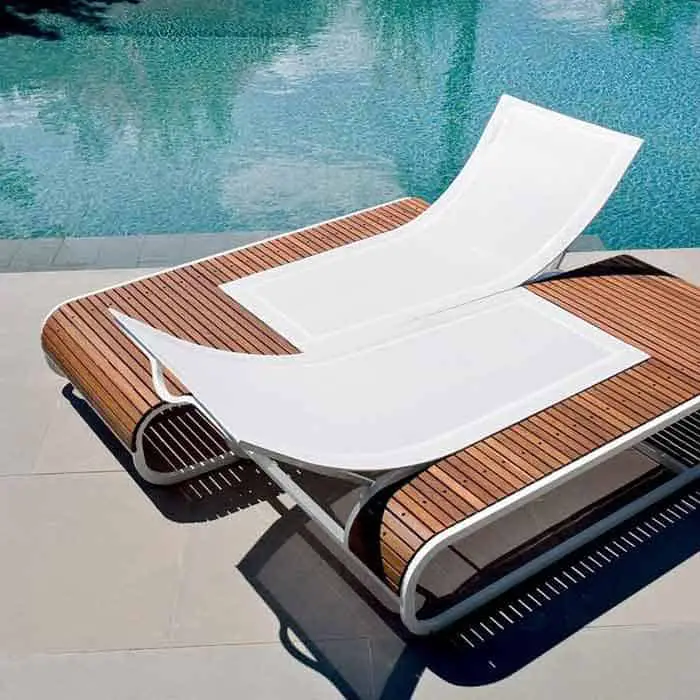 Two adjustable mesh sunloungers face each other, set in a curved base of wooden slats.