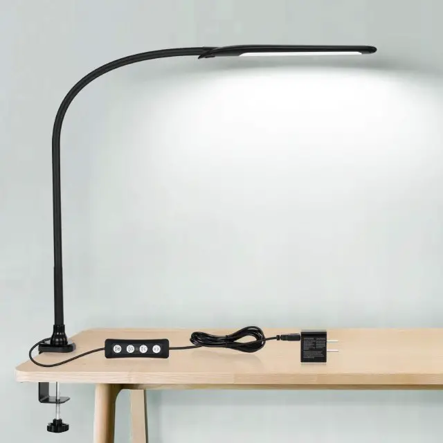 The HAILOLY Gooseneck Clamp Lamp is a sturdy metal clamp that can be bent to practically any angle and is 360 º rotatable. It has a wide range of brightness without flicker and a USB charging plug  at the base of the lamp.