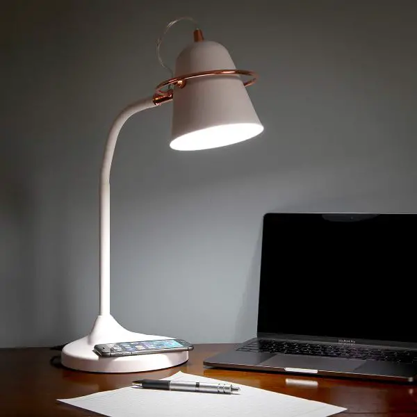 The multi-use Brightech Zoey Lamp charges devices wirelessly. Other features are the adjustable gooseneck head and a touch switch.